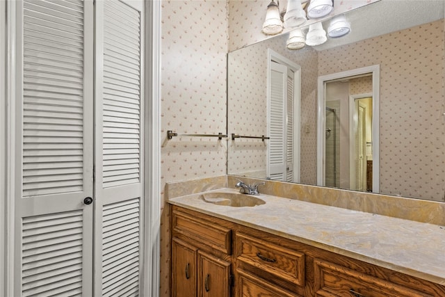979 Rockdale, Sulphur Springs, TX 75482 - bathroom featuring wallpapered walls, a closet, vanity, a stall shower, and a chandelier