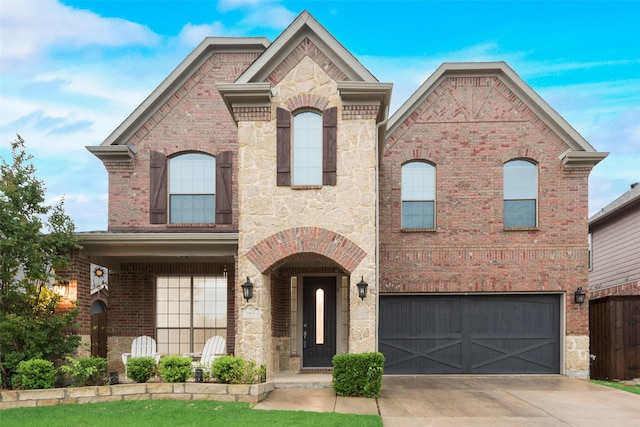 305 Blythe Bridge Dr, Roanoke, TX 76262 - french provincial home featuring an attached garage, concrete driveway, brick siding, and stone siding