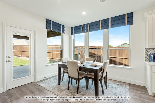 dining area featuring wood finished floors, baseboards, and recessed lighting