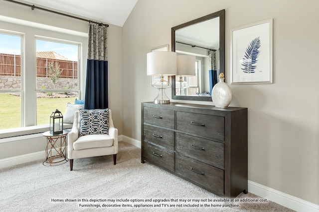 living area featuring vaulted ceiling, baseboards, and carpet floors