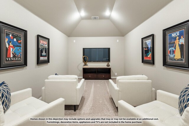 home theater room featuring vaulted ceiling and carpet