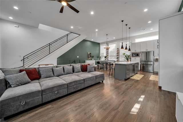 living room with recessed lighting, ceiling fan, stairs, and dark wood-style flooring