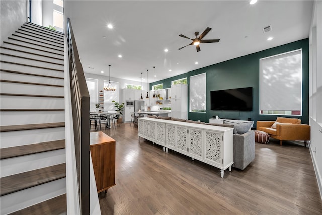 living room with stairs, ceiling fan, recessed lighting, and dark wood-style flooring