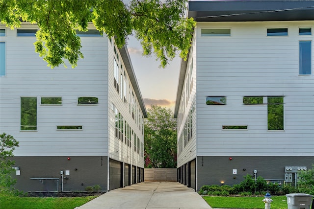 view of property featuring concrete driveway
