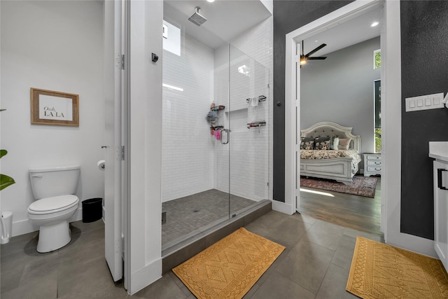full bathroom featuring a stall shower, a ceiling fan, tile patterned floors, toilet, and vanity