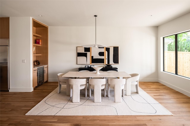 9834 Shoreview Rd, Dallas, TX 75238 - dining space with wine cooler, wood finished floors, baseboards, and recessed lighting