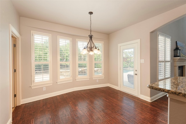 4016 Muscovy Dr, Mckinney, TX 75072 - unfurnished dining area with dark wood-style flooring, a chandelier, and baseboards