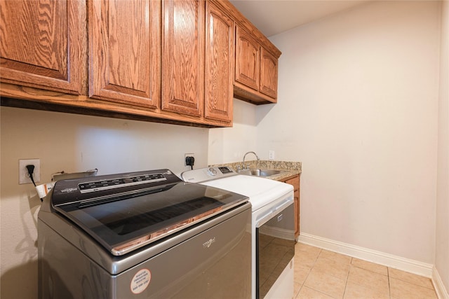 4016 Muscovy Dr, Mckinney, TX 75072 - laundry area featuring cabinet space, washer and dryer, baseboards, and light tile patterned flooring
