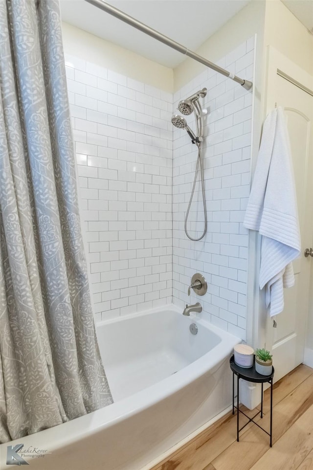 full bathroom featuring wood finished floors and shower / bathtub combination with curtain