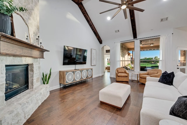 308 Pioneer Ct, Mclendon Chisholm, TX 75032 - living area with ceiling fan, arched walkways, beam ceiling, wood finished floors, and a fireplace