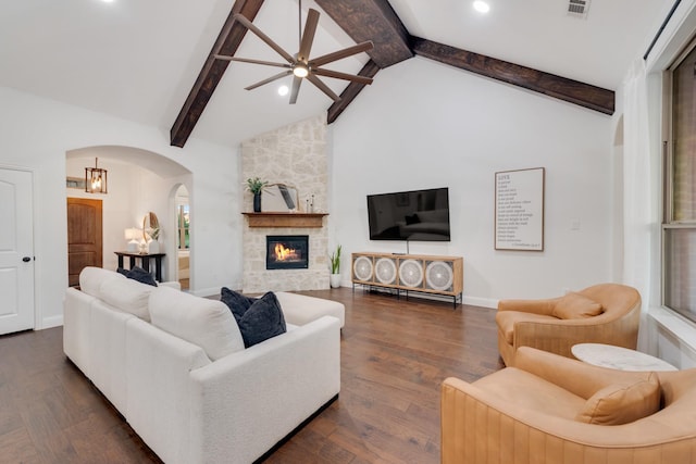 308 Pioneer Ct, Mclendon Chisholm, TX 75032 - living room with arched walkways, ceiling fan, beamed ceiling, dark wood-style floors, and a stone fireplace