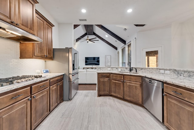 308 Pioneer Ct, Mclendon Chisholm, TX 75032 - kitchen featuring stainless steel appliances, a sink, under cabinet range hood, light stone countertops, and decorative backsplash