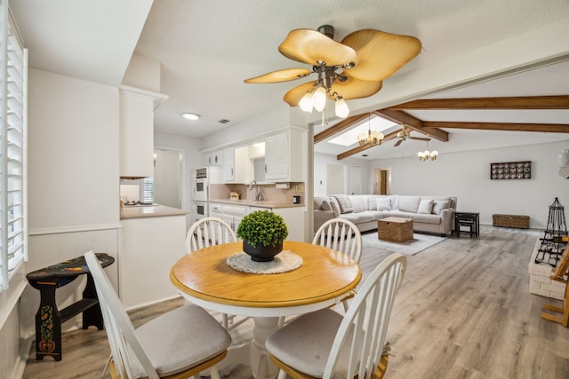 614 Willowbrook Cir, Duncanville, TX 75116 - dining room with light wood finished floors, ceiling fan, and a chandelier