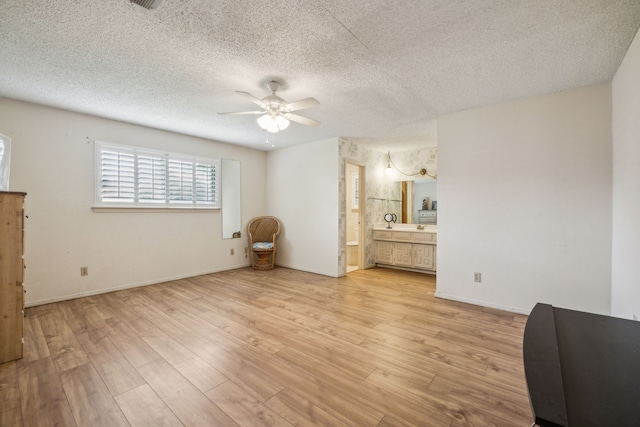 614 Willowbrook Cir, Duncanville, TX 75116 - bedroom with light wood finished floors, a textured ceiling, ensuite bath, and baseboards