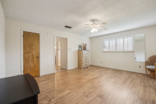 614 Willowbrook Cir, Duncanville, TX 75116 - bedroom featuring light wood finished floors, a textured ceiling, a ceiling fan, and baseboards