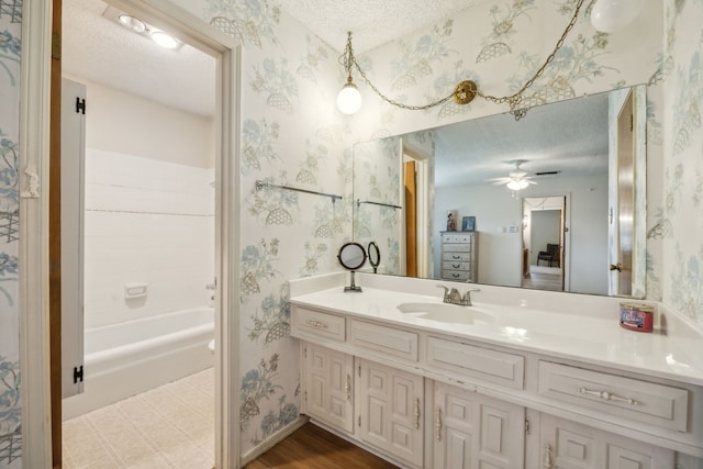 614 Willowbrook Cir, Duncanville, TX 75116 - full bath featuring a textured ceiling, wallpapered walls, vanity, and a ceiling fan