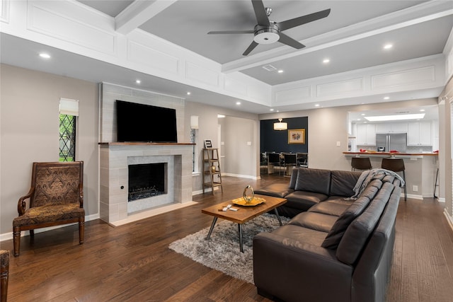 7610 Bantry Cir, Dallas, TX 75248 - living room with a ceiling fan, dark wood-style flooring, a large fireplace, beam ceiling, and baseboards