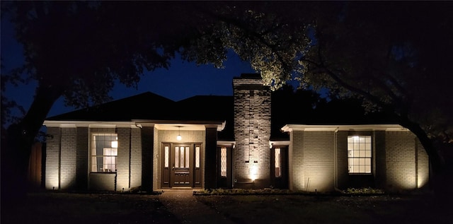 7610 Bantry Cir, Dallas, TX 75248 - view of front of house with a chimney and brick siding