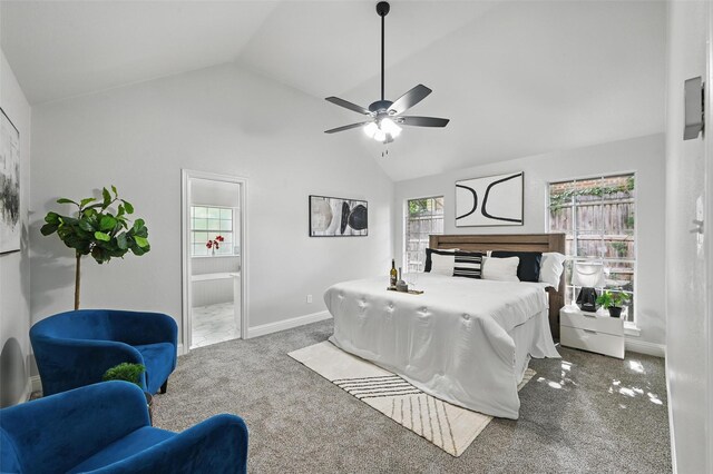bedroom featuring carpet flooring, baseboards, ensuite bath, high vaulted ceiling, and a ceiling fan