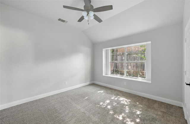 carpeted spare room featuring baseboards, ceiling fan, and lofted ceiling