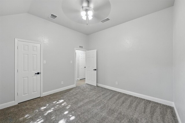 unfurnished bedroom with carpet, vaulted ceiling, baseboards, and a ceiling fan