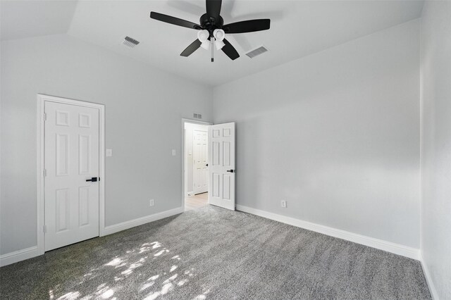 unfurnished bedroom with carpet flooring, vaulted ceiling, baseboards, and ceiling fan