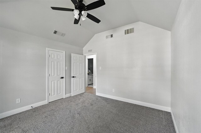 unfurnished bedroom with vaulted ceiling, carpet, baseboards, and a ceiling fan