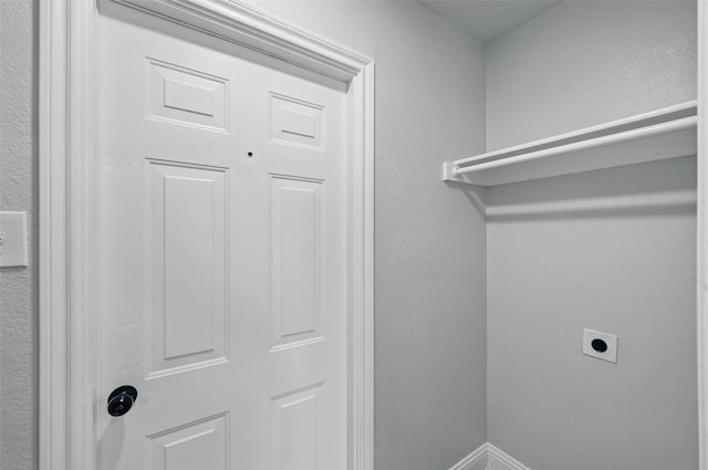 washroom with hookup for an electric dryer and baseboards