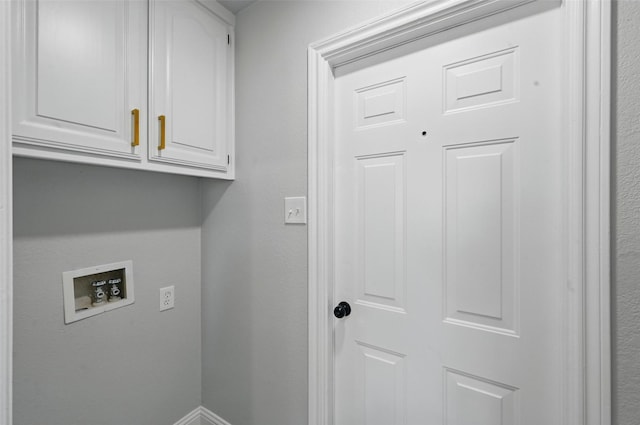 laundry area with washer hookup and cabinet space