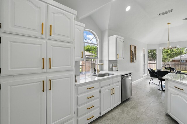 kitchen with a sink, stainless steel dishwasher, a chandelier, light countertops, and plenty of natural light