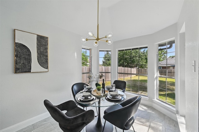 dining room with baseboards and a chandelier