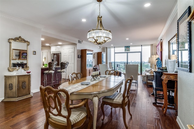 dining room featuring crown molding, a chandelier, dark wood-style flooring, and recessed lighting