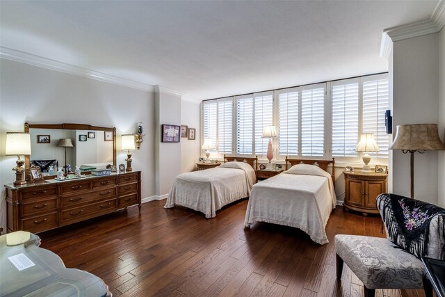 bedroom featuring dark wood finished floors, multiple windows, ornamental molding, and baseboards
