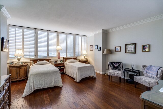 bedroom featuring ornamental molding, dark wood-style flooring, and baseboards