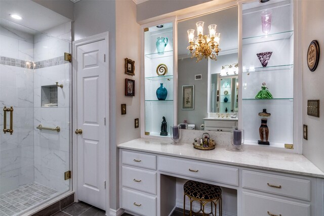 bathroom with a shower stall, vanity, a chandelier, and toilet