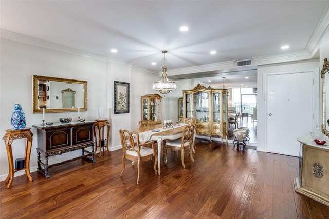 dining room featuring dark wood-style flooring, a chandelier, crown molding, recessed lighting, and baseboards