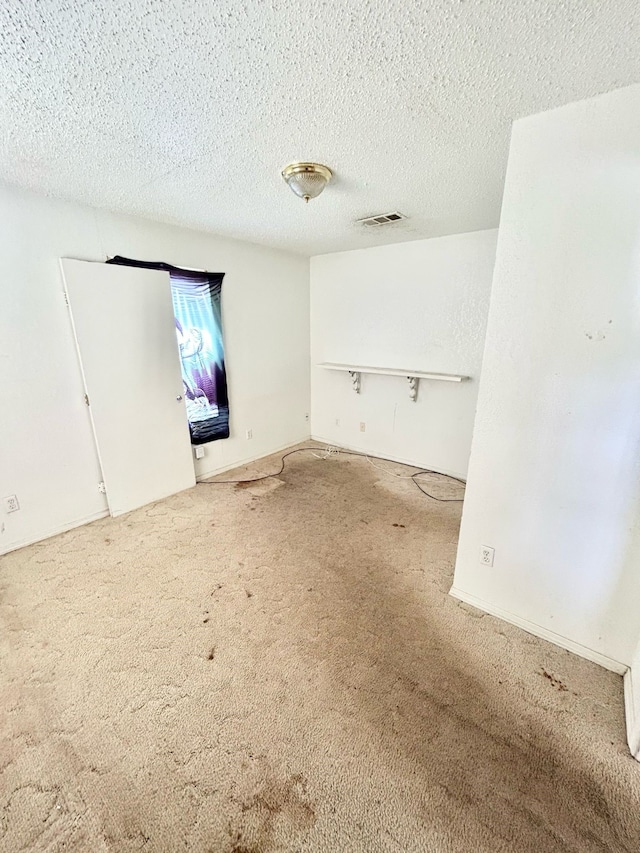3601 Avenue N, Fort Worth, TX 76105 - spare room featuring carpet and a textured ceiling