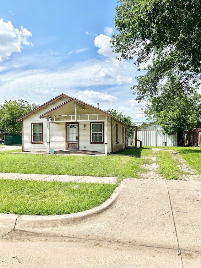 3601 Avenue N, Fort Worth, TX 76105 - view of front of home with dirt driveway, a front yard, and a porch