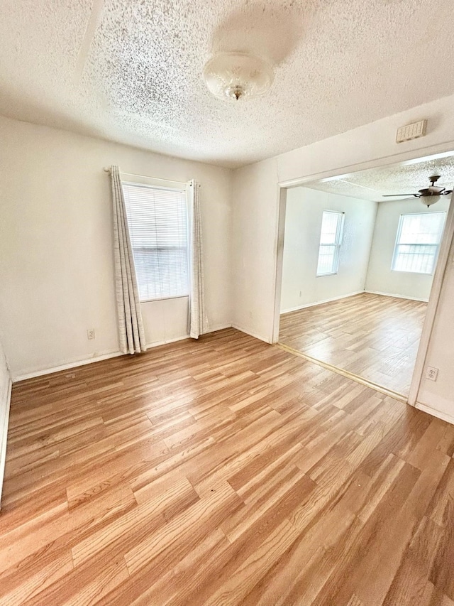 3601 Avenue N, Fort Worth, TX 76105 - unfurnished room with a textured ceiling and light wood-type flooring