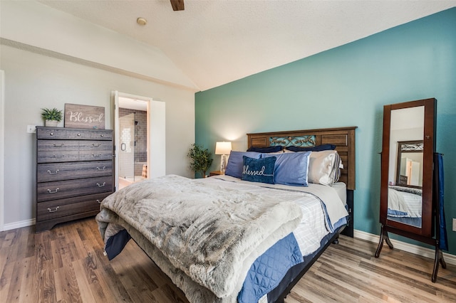1361 Daffodil Ln, Lewisville, TX 75077 - bedroom with lofted ceiling, wood finished floors, baseboards, and ensuite bath