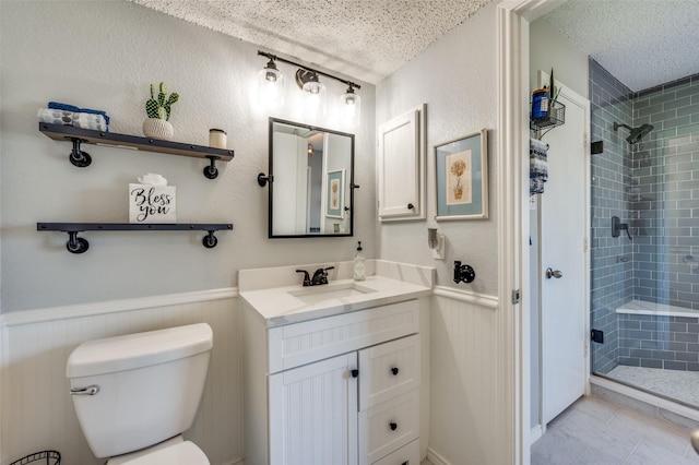 1361 Daffodil Ln, Lewisville, TX 75077 - full bath with a textured ceiling, a stall shower, toilet, vanity, and a wainscoted wall