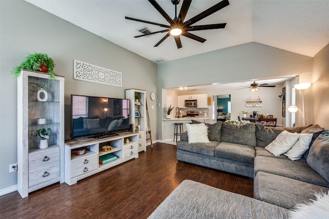1361 Daffodil Ln, Lewisville, TX 75077 - living area with ceiling fan, vaulted ceiling, dark wood-style flooring, and baseboards