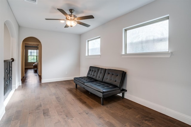 1043 Sarah St, Allen, TX 75013 - living area with arched walkways, healthy amount of natural light, and wood finished floors