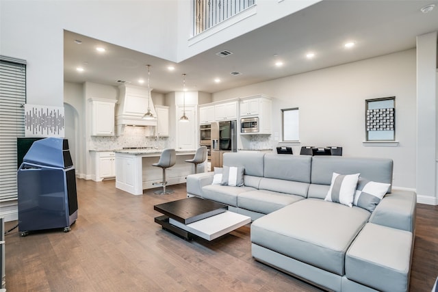1043 Sarah St, Allen, TX 75013 - living area featuring dark wood finished floors, a towering ceiling, baseboards, and recessed lighting