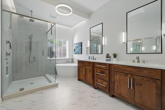 bathroom featuring marble finish floors, a stall shower, a freestanding tub, and double vanity