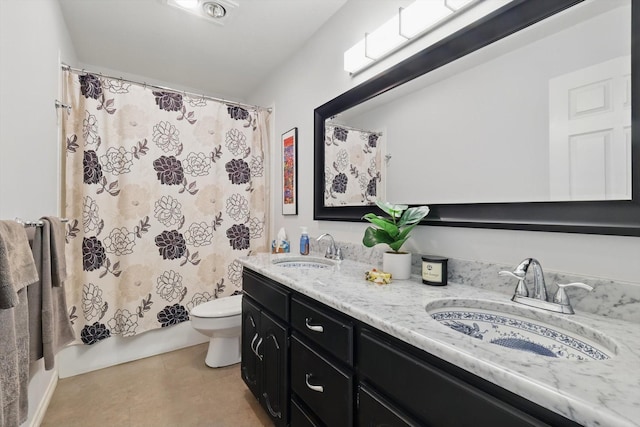 full bathroom featuring toilet, double vanity, and tile patterned flooring