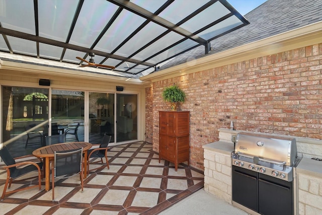 view of patio featuring area for grilling, grilling area, outdoor dining area, and ceiling fan