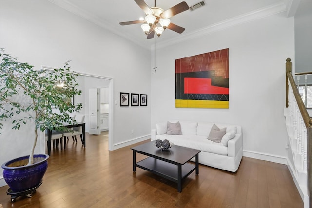 living room featuring ornamental molding, a ceiling fan, wood finished floors, and baseboards