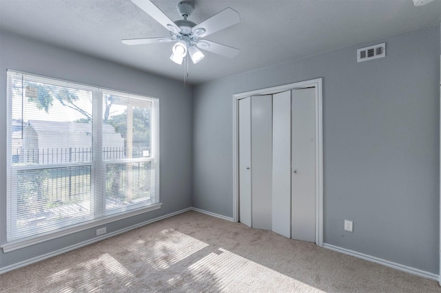 8721 N Normandale St, Fort Worth, TX 76116 - unfurnished bedroom with carpet, a closet, baseboards, and a ceiling fan