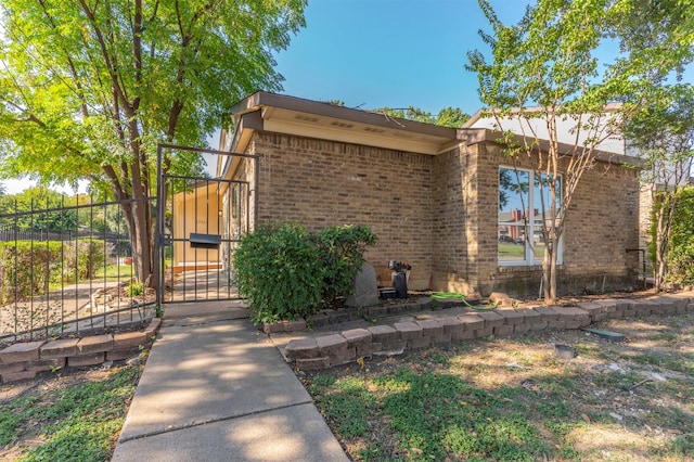8721 N Normandale St, Fort Worth, TX 76116 - view of front facade featuring brick siding and a gate